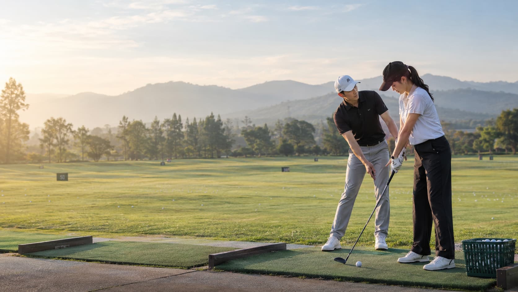 Golf lesson at sunrise with mountains in the background